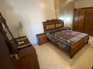 a bedroom with a bed and a telephone in it at Nador Holidays in Nador