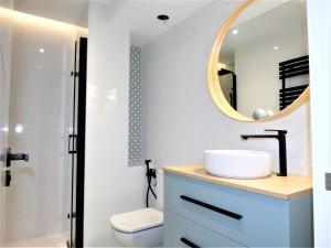 a bathroom with a sink and a mirror at GRAN BILBAO I in Barakaldo +68 photos