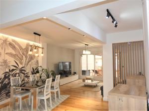 a dining room and living room with a table and chairs at GRAN BILBAO I in Barakaldo