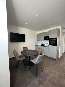 a kitchen and dining room with a table and chairs at 4-Living Apartment Houses in Nuremberg