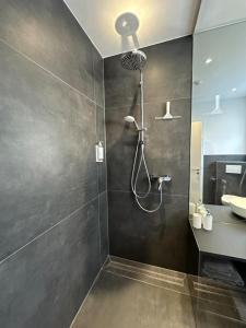 a bathroom with a shower and a sink at 4-Living Apartment Houses in Nuremberg