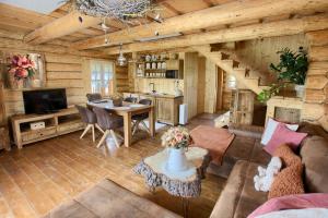 a living room with a couch and a table in a cabin at Penzión Zbojnícky Halaš in Tisovec