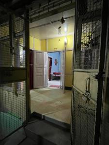 an empty room with a door and a room with a hallway at Hemalata Heritage Home in Guwahati