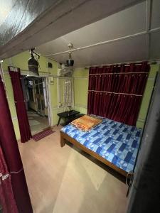 a bedroom with a bed and a table in a room at Hemalata Heritage Home in Guwahati