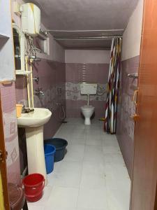 a bathroom with a toilet and a sink at Hemalata Heritage Home in Guwahati