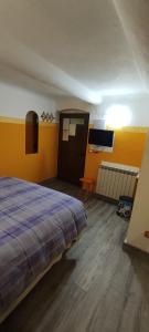 a bedroom with a bed and a flat screen tv at Affittacamere "In Piazzetta da Vasco" in Lerici