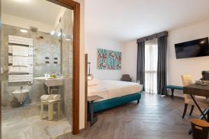 a bedroom with a bed and a shower and a sink at Ancora Sport Hotel in Meolo