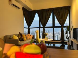 a living room with a couch and a large window at Urban Suites by PerfectSweetHome with Home Feel L in Jelutong