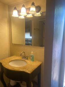 a bathroom with a sink and a mirror at Park Model Furnished #5 in Tucson