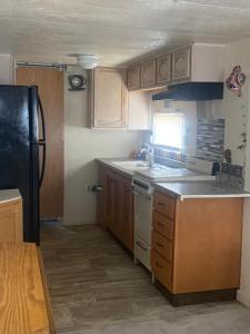 a small kitchen with a sink and a refrigerator at Park Model Furnished #5 in Tucson