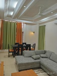 a living room with a couch and a table at Timba Deluxe in Cotonou