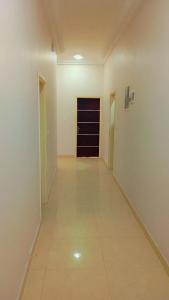an empty hallway with a door in a room at Timba Deluxe in Cotonou