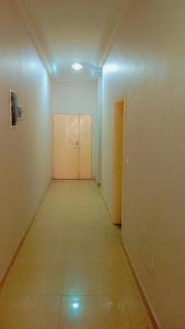 an empty room with a hallway with a door at Timba Deluxe in Cotonou