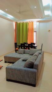 a living room with two beds and a couch at Timba Deluxe in Cotonou