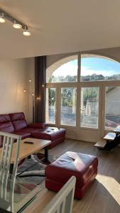 a living room with a couch and a table at Maison de campagne - Chez Félicien in Recologne-lès-Rioz