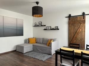 a living room with a couch and a table at Cozy seaside park apartment in Liepāja