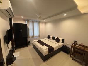 a bedroom with a bed and a television in it at Hotel Life Inn in Jaipur