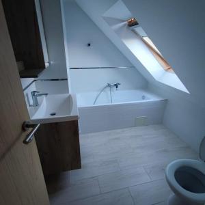 a bathroom with a sink and a bath tub at Super Family/Office Apartment in Budaörs in Budaörs