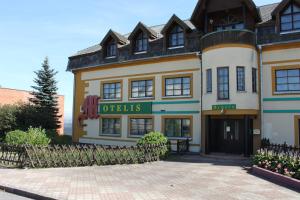 a building with a gate in front of it at Samana in Tytuvėnai