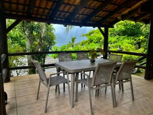 a table and chairs on a patio with a view at SUNSET PORTO BELO Locaçoes in Porto Belo