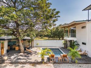 un cortile con piscina e un albero di Tropical Escape Private Pool & Outdoor Kitchen a Sardinal