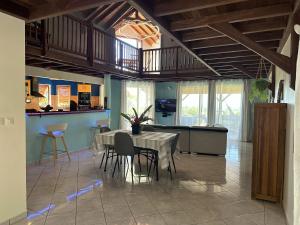 a dining room with a table and chairs at Maison de 3 chambres a Deshaies a 850 m de la plage avec vue sur la mer piscine partagee et jardin clos in Deshaies