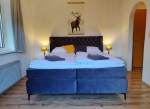 a bedroom with a large bed with a deer above it at Pension Almhof in Afritz