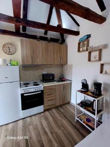 a kitchen with a stove and a white refrigerator at Panthea Residence in Theológos +39 photos