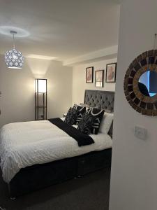 a bedroom with a bed and a mirror on the wall at Margate Apartment in Kent