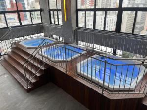 a cage with a swimming pool on top of a building at Hotel das Américas in Balneário Camboriú