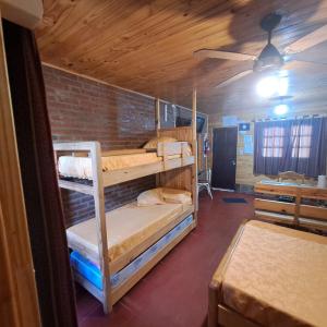 a room with two bunk beds and a brick wall at Las Moras in Reyes