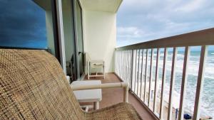 a balcony with a view of the ocean at Sunkissed-Modern Oceanfront Condo Daytona Beach in Daytona Beach