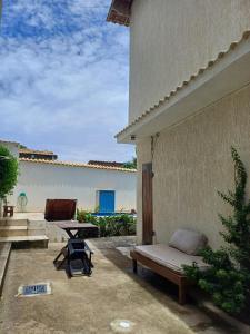 a patio with a bench and a table at Renascer Suites in Búzios +14 photos