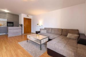 a living room with a couch and a coffee table at Bansko Ski & Relax Apartment in Bansko
