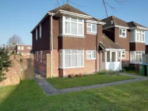 a brick house with a fence in the yard at 1 Bed Bognor Apartment 300 yrds from beach in Bognor Regis