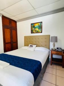 a hotel room with two beds and a night stand at Hostal Clary in León