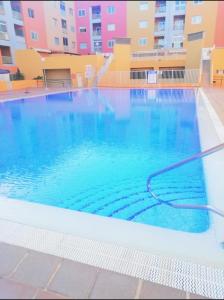 a large swimming pool with a hose in the water at APARTAMENTO NAIR in Candelaria