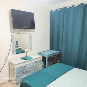 カンデラリアにあるAPARTAMENTO NAIRのベッドルーム(ベッド1台、鏡、テレビ付)