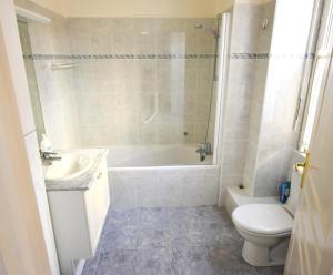 a bathroom with a tub and a sink and a toilet at Jardin des Muses -Parking privé - Centre-Ville - Bord de Mer in Menton