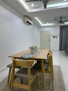 a dining room with a wooden table and chairs at Havengate Homestay in Butterworth