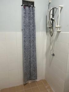 a shower with a shower curtain in a bathroom at Havengate Homestay in Butterworth