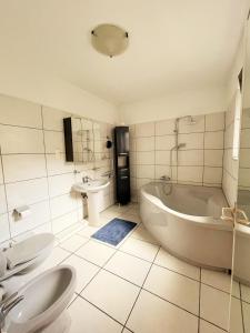 a bathroom with a tub and a toilet and a sink at Friesenwall Apartments in Cologne