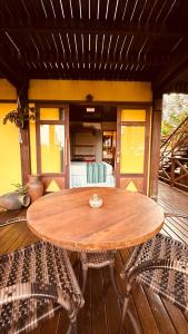 a wooden table and two chairs on a patio at Pousada Pedras Secas in Fernando de Noronha