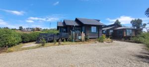 a house sitting on top of a gravel road at Casa Pascual in Dalcahue