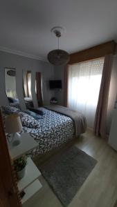 Un dormitorio con una cama grande y una ventana en Mi casita en A Coruña