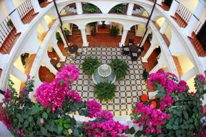 
a large staircase leading to a garden filled with flowers at Hotel La Fonda in Benalmádena
