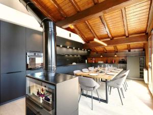 a kitchen with a dining table and a stove at Chalet La Tania, 6 pièces, 10 personnes - FR-1-575-202 in Courchevel