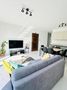 a living room with a couch and a tv at Sliema 2 Bedroom Penthouse in Sliema