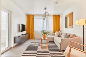 a living room with a couch and a tv at Olivia -Einzigartiges Wohnerlebnis in Kaiserslauterns Herz in Kaiserslautern