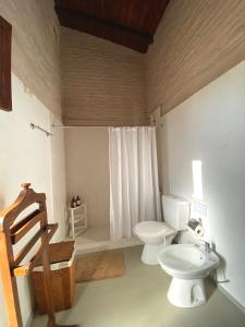 a bathroom with a toilet and a sink at Casa en Haras Bettina in Mercedes